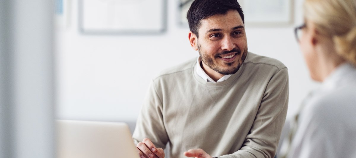 Businessman sharing ideas with colleague in meeting