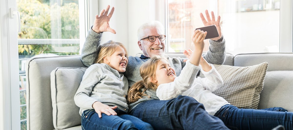 Grandfather taking selfie with kids
