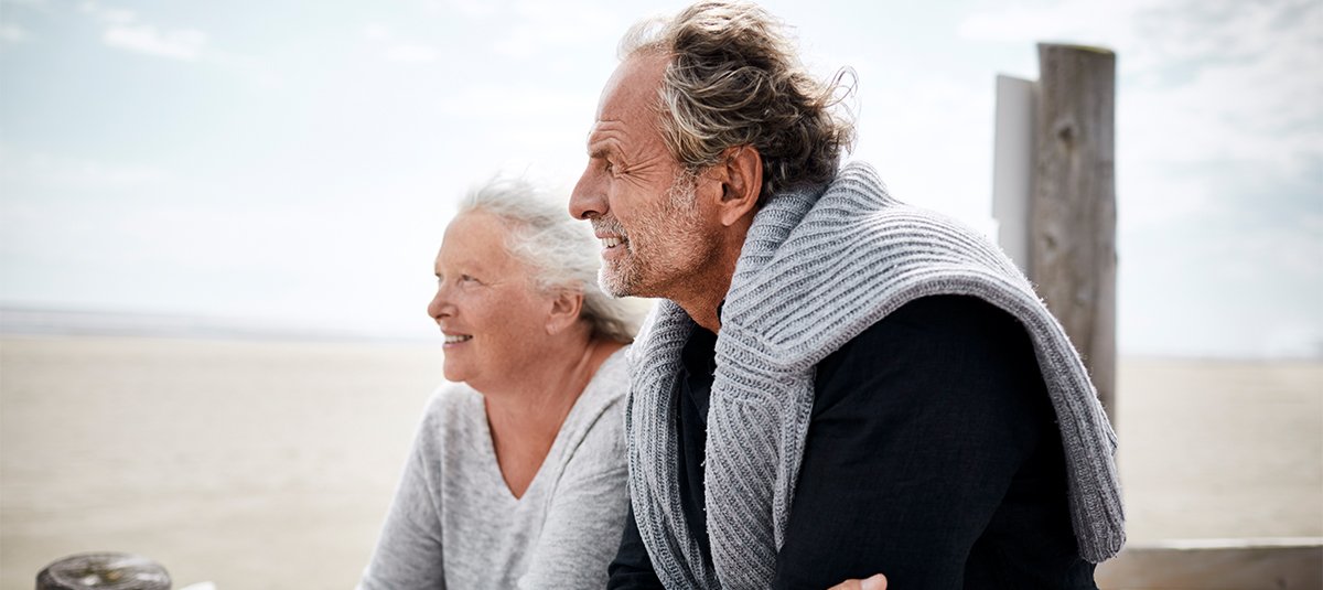 Old couple looking far and smiling